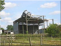 TL1513 : Damaged hay shed at The Grove Harpenden by Jack Hill