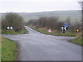 Main road left, no through road right, farm ahead.