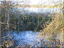 SU0394 : River Thames in foreground perched above flooded gravel pit by Peter Watkins