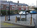 Great Barrow village hall, pump in the foreground.