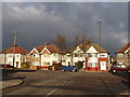 TQ1374 : Nelson Road, Whitton - sun and dark sky by David Hawgood