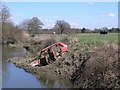 Derelict car on river bend