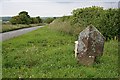 SX4375 : Boundary Stone and Road by Tony Atkin