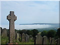 NZ9405 : Graveyard of St. Stephen's church and mist over Robin Hood's Bay. by Margaret Clough