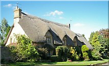 SP1438 : Cotswold stone, thatched house by Jennifer Luther Thomas