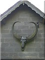 Animal head with enormous horns on gable end of Hempsyke Farm