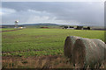 Straw bales, a pub, and an aerial on Allans Hill