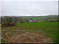 View across farmland to farm