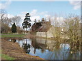 Middle farm buildings reflected in pond