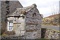 Old schoolhouse porch made from Roman stones brought from the fort at Bremenium