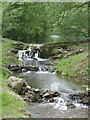 Small water cascade by roadside near Fairbourne Mill