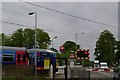TL4048 : Level crossing at Foxton, with First Capital Connect train leaving station by Fractal Angel