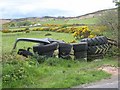 J1210 : Barrier of tyres at Mullaghattin by Oliver Dixon