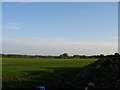 View beyond the dung heap of arable land