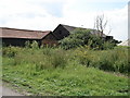 TL2577 : Converted barns at Lodge Farm by Simon Mortimer
