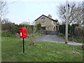 Post box and house in Lower Welson