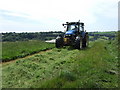 Tractor cutting hay