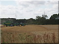 Combine harvester cutting wheat field