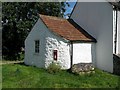 Old whitewashed cottage at Priddy