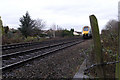 Train approaching foot level-crossing