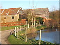 Pond and outbuildings by Burstall Hall