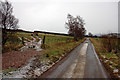 Minor road, gate and track across field