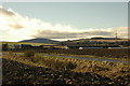 Looking across the fields to the farm and industrial buildings at Cowley