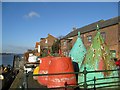 Old buoys huddled together on the quayside