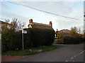 Finger-post in Garmston with The Wrekin in the background.