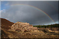 NJ0849 : Timber pile by Clashninian under a rainbow by Des Colhoun