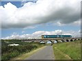 A Holyhead-bound  Arriva Wales train on  the Malltraeth Viaduct