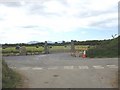 New entrance and driveway through a meadow with baled silage