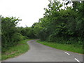 Country lane with the entrance to Blochdy on the right