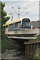 Tram crossing the River Leen