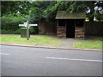 TL3746 : Meldreth: Marvell's green bus stop shelter and finger post by Nigel Cox