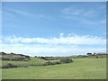 View across farmland and a (hidden) expressway interchange to Bwlcyn farmhouse