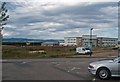 Office building viewed across convenience food carpark