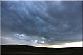 NY7405 : Glowering sky looking north from the A685, with cumulus mammatus cloud by Adrian Beney