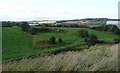 Partially filled quarry with industrial units behind