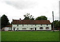 Row of terraced cottages by the village green