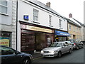 Sign for one shop above another