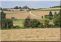 Field with track rising beyond